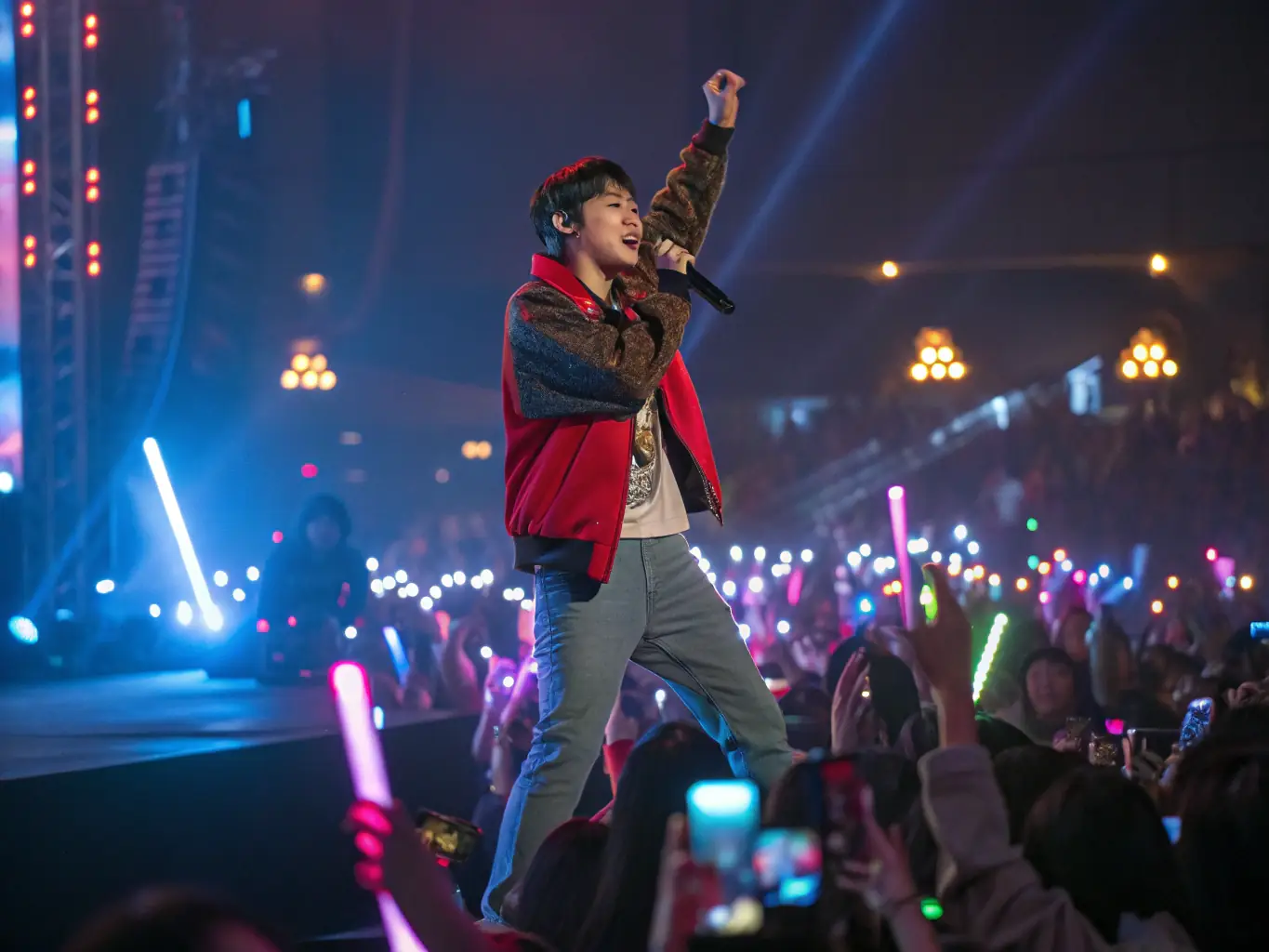 A vibrant scene from a K-POP music performance event, featuring a solo artist singing on stage with dynamic lighting and a cheering audience, capturing the energy and excitement of the live performance.